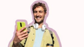 Ein Mann, der in seiner rechten Hand ein Smartphone hält und lächelnd darauf blickt.