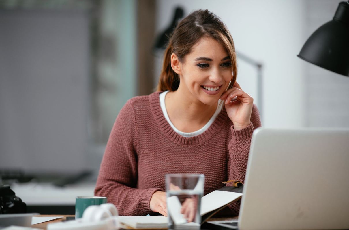 Frau am Laptop bei Online-Rufnummernmitnahme